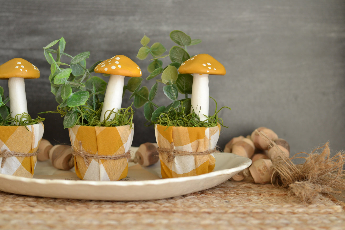 Golden painted mushroom in gingham pot
