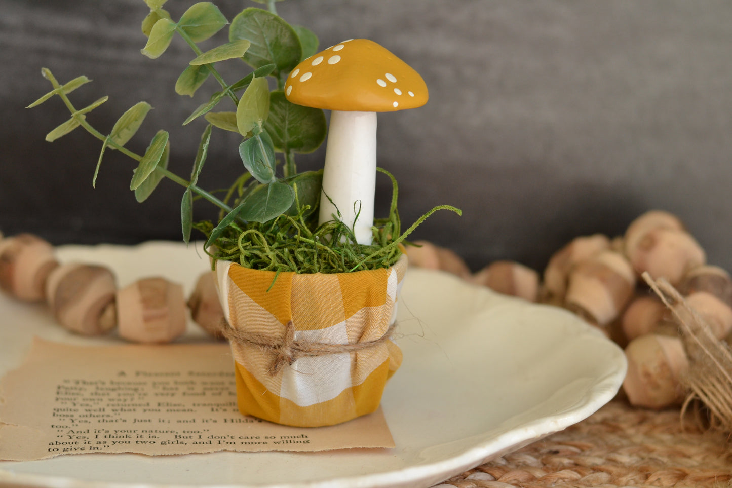 Golden painted mushroom in gingham pot