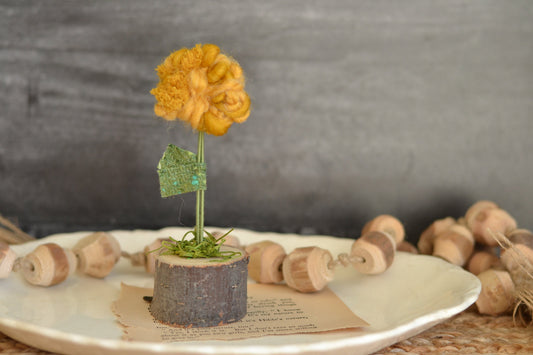 Mustard yarn flower on Log Slice