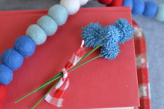 Bundle of blue faux flowers with gingham fabric ribbon tie